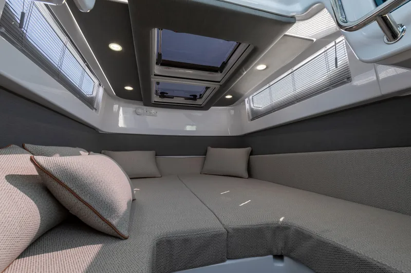 Slide: The Image of Luxurious interior of 2024 Axopar 37 Sun Top boat with comfortable seating and skylight. - 7