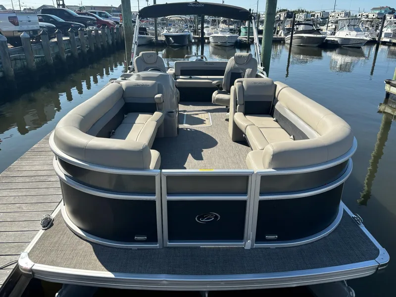 Slide: The Image of 2021 Barletta C24UC pontoon boat docked at marina, featuring spacious seating. - 3