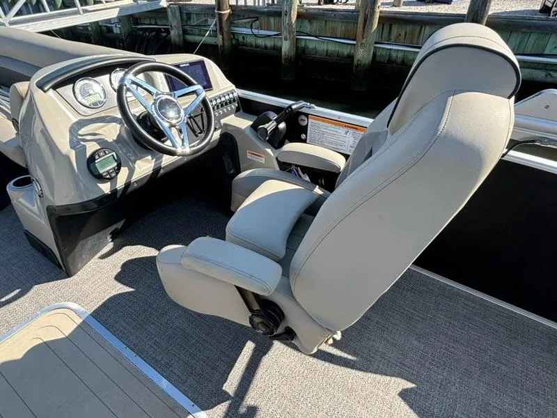 Slide: The Image of 2021 Barletta C24UC boat interior with steering wheel and captain's chair. - 5