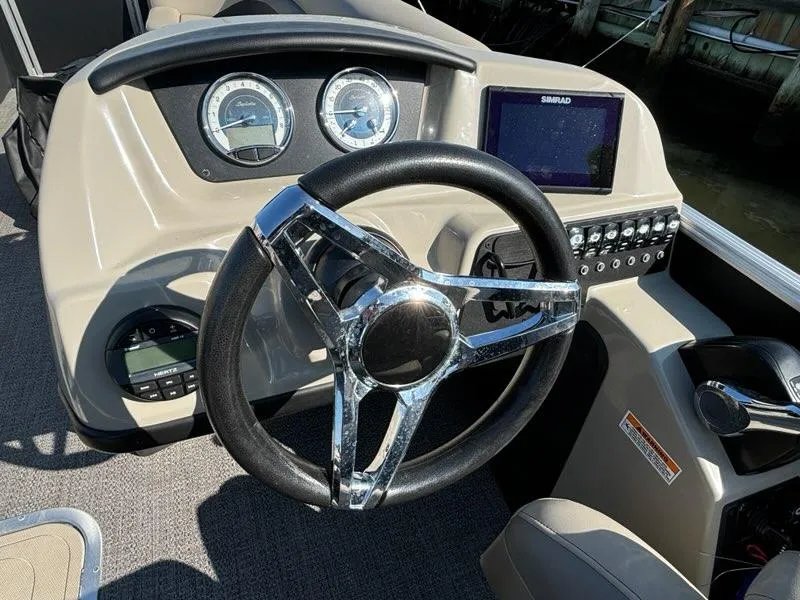 Slide: The Image of Barletta C24UC 2021 boat dashboard with steering wheel and control panel. - 6