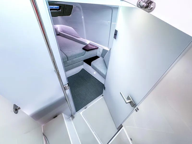 Slide: The Image of 2024 Axopar 37 Sun Top cabin interior with modern seating and sleek design. - 16
