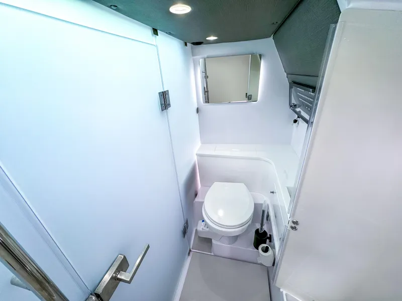 Slide: The Image of 2024 Axopar 37 Sun Top bathroom interior with modern fixtures and sleek design. - 18