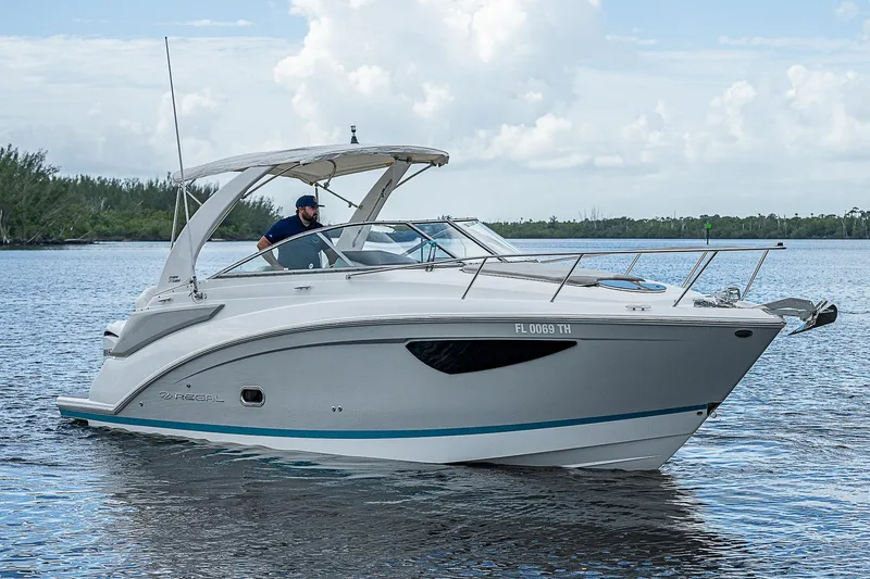 Slide: The Image of 2022 Regal 26 XO boat cruising on a calm lake. - 0