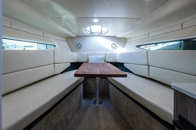 Slide: The Image of Luxurious interior of 2022 Regal 26 XO boat with plush seating and wooden table. - 1