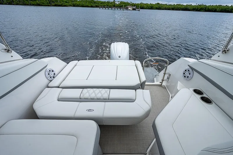 Slide: The Image of 2022 Regal 26 XO boat interior with plush seating and scenic water view. - 12