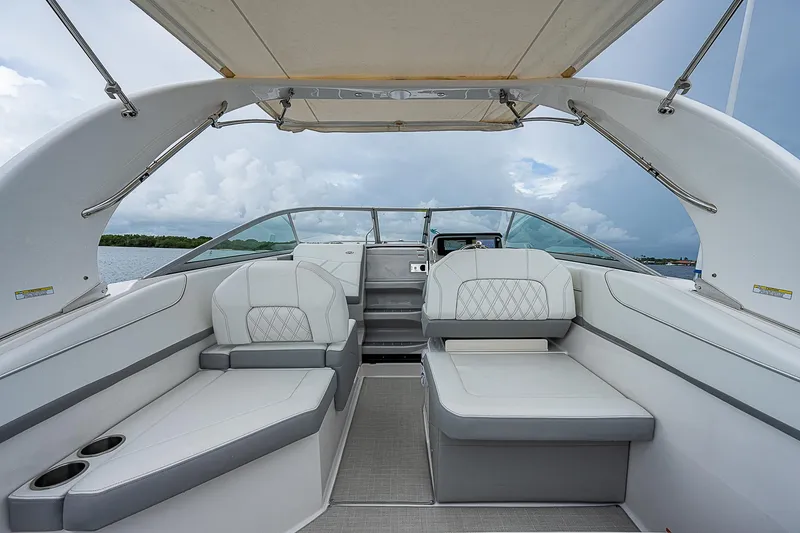 Slide: The Image of 2022 Regal 26 XO boat interior with spacious seating and canopy. - 13
