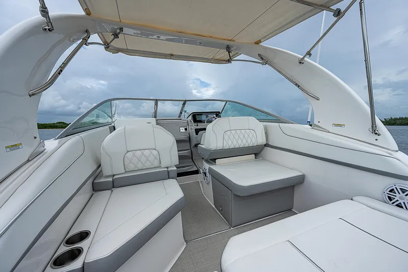 Slide: The Image of 2022 Regal 26 XO boat interior with white seating and canopy. - 14