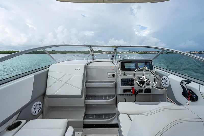 Slide: The Image of 2022 Regal 26 XO boat interior with modern helm and seating on open water. - 15