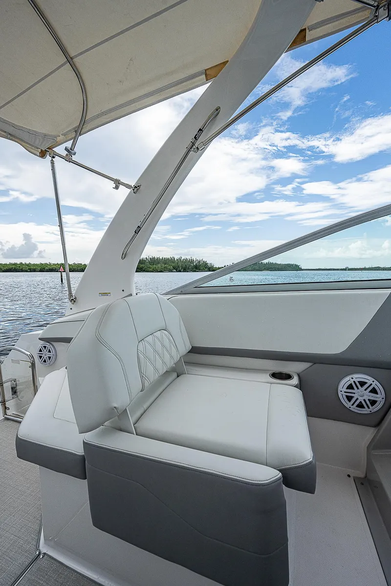 Slide: The Image of 2022 Regal 26 XO boat interior with plush seating and scenic water view. - 19