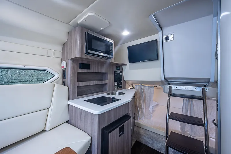 Slide: The Image of 2022 Regal 26 XO cabin interior with kitchenette, seating, and modern amenities. - 2