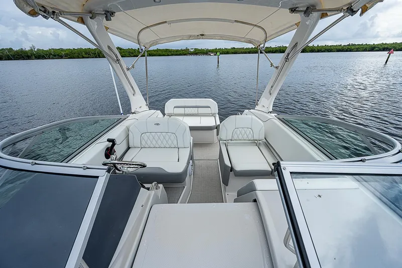 Slide: The Image of 2022 Regal 26 XO boat interior with spacious seating on a calm lake. - 23