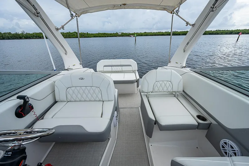 Slide: The Image of 2022 Regal 26 XO boat interior with white seating, open water view. - 24