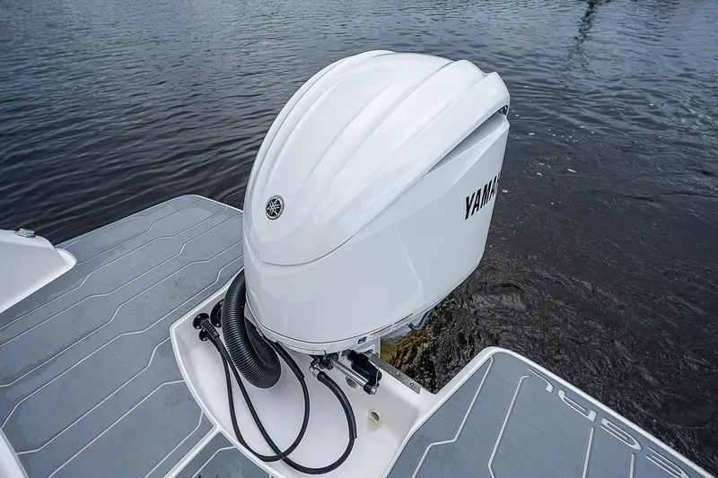 Slide: The Image of 2022 Regal 26 XO boat with Yamaha outboard motor on water. - 26
