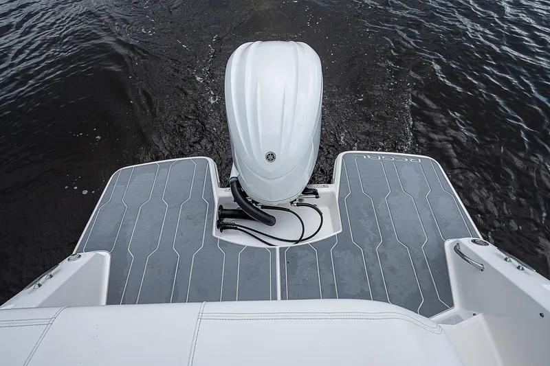 Slide: The Image of 2022 Regal 26 XO boat stern with outboard motor on water. - 29