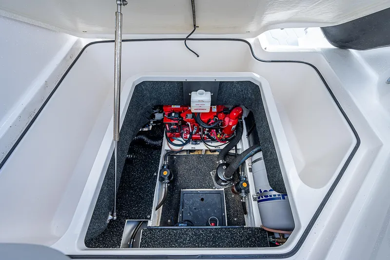 Slide: The Image of 2022 Regal 26 XO engine compartment with red components and clean interior. - 30