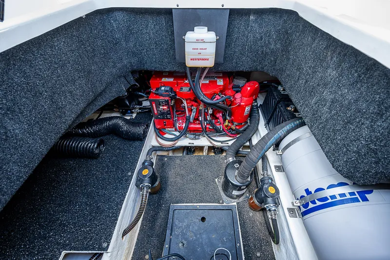 Slide: The Image of Engine compartment of 2022 Regal 26 XO boat, featuring red engine and components. - 31