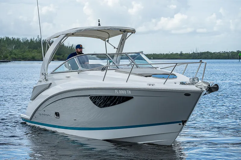 Slide: The Image of 2022 Regal 26 XO boat cruising on a calm lake. - 36