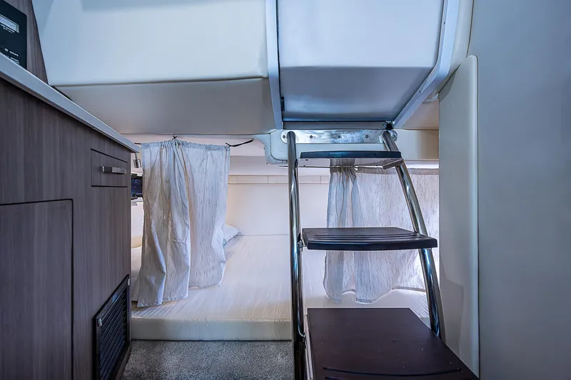Slide: The Image of Interior cabin of 2022 Regal 26 XO boat with bunk beds and ladder. - 4