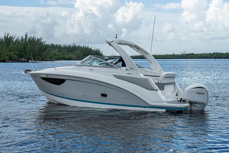 Slide: The Image of 2022 Regal 26 XO boat on calm water with cloudy sky background. - 45