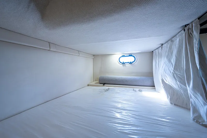 Slide: The Image of 2022 Regal 26 XO cabin interior with bed and porthole window. - 6