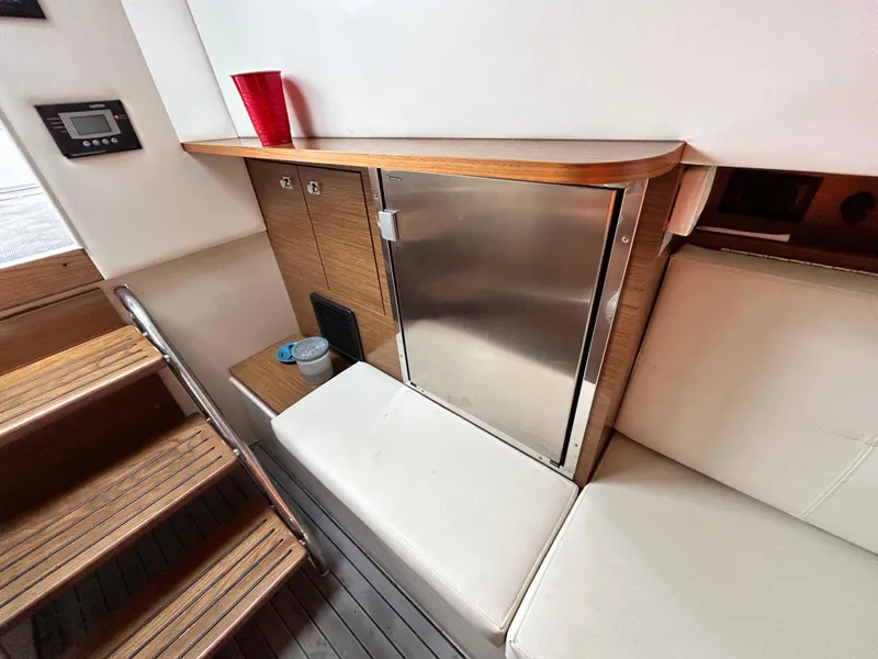 Slide: The Image of Interior of 2017 Cruisers Yachts 338 Sport Series with seating and mini fridge. - 10