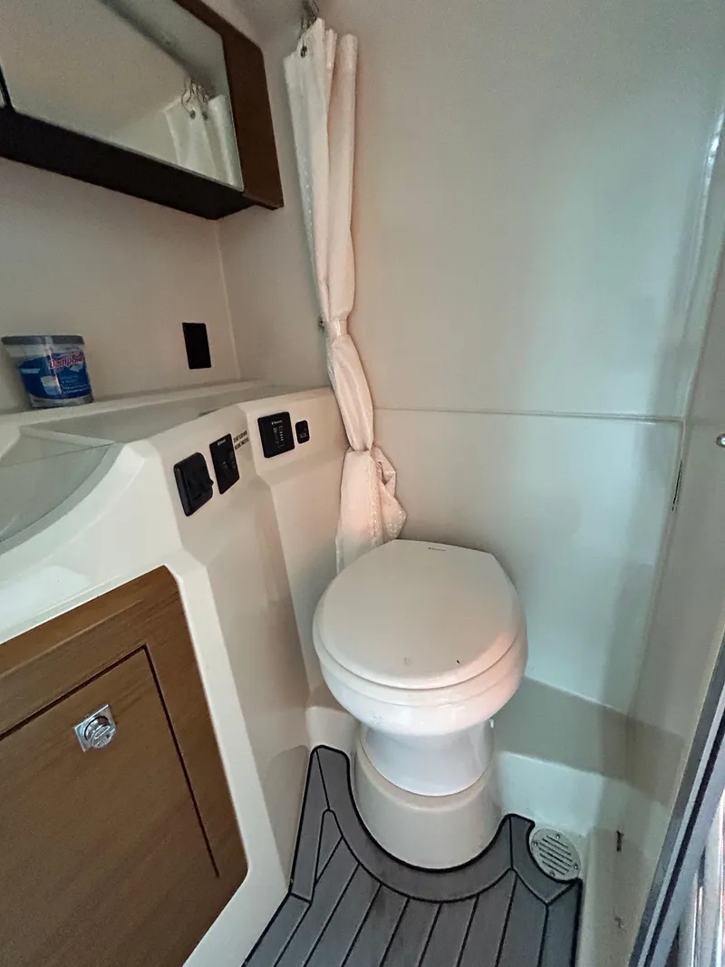 Slide: The Image of 2017 Cruisers Yachts 338 Sport Series bathroom with modern fixtures and wood accents. - 12