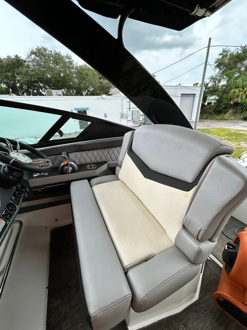 Slide: The Image of 2017 Cruisers Yachts 338 Sport Series interior with plush seating and modern dashboard. - 15