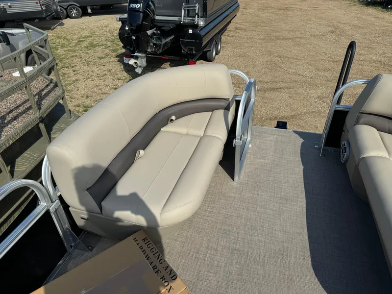 Slide: The Image of 2025 Sun Tracker Party Barge 16 DLX with beige seating on a sunny day. - 12