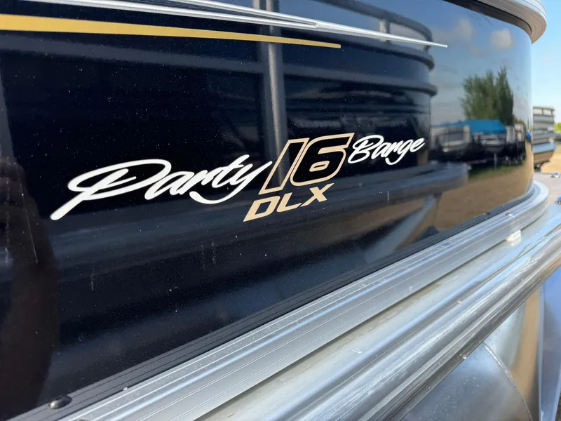 Slide: The Image of 2025 Sun Tracker Party Barge 16 DLX logo on boat exterior. - 6