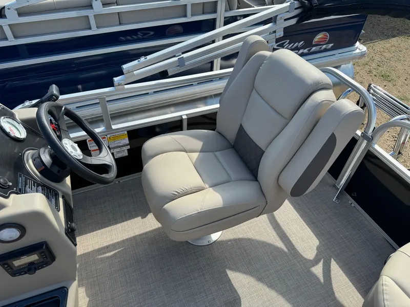 Slide: The Image of 2025 Sun Tracker Party Barge 16 DLX interior with captain's chair and steering wheel. - 7