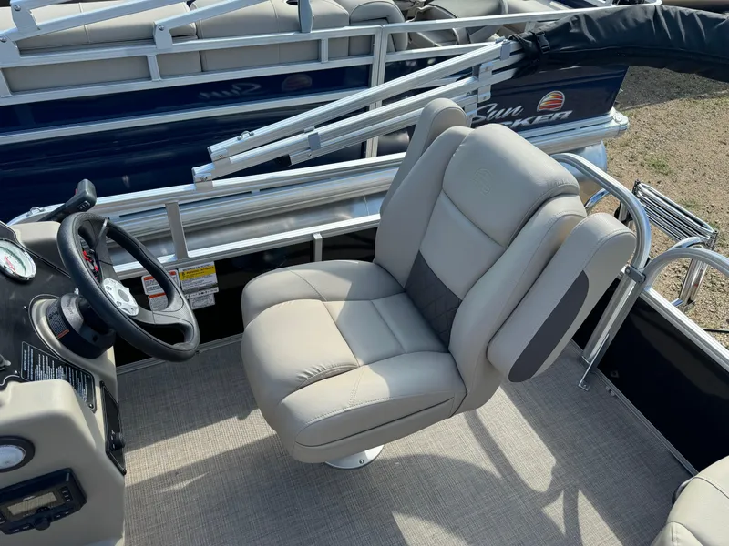 Slide: The Image of 2025 Sun Tracker Party Barge 16 DLX captain's chair and steering console. - 9