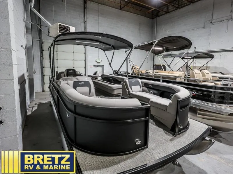 Slide: The Image of 2025 Aria Cast-N-Cruise A22CC pontoon boat in showroom at Bretz RV & Marine. - 1