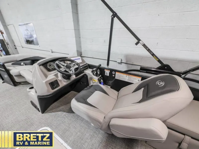 Slide: The Image of 2025 Aria Cast-N-Cruise A22CC boat interior with steering console and seating. - 11