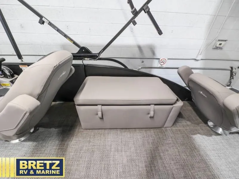 Slide: The Image of 2025 Aria Cast-N-Cruise A22CC boat interior with gray seating and storage. - 12