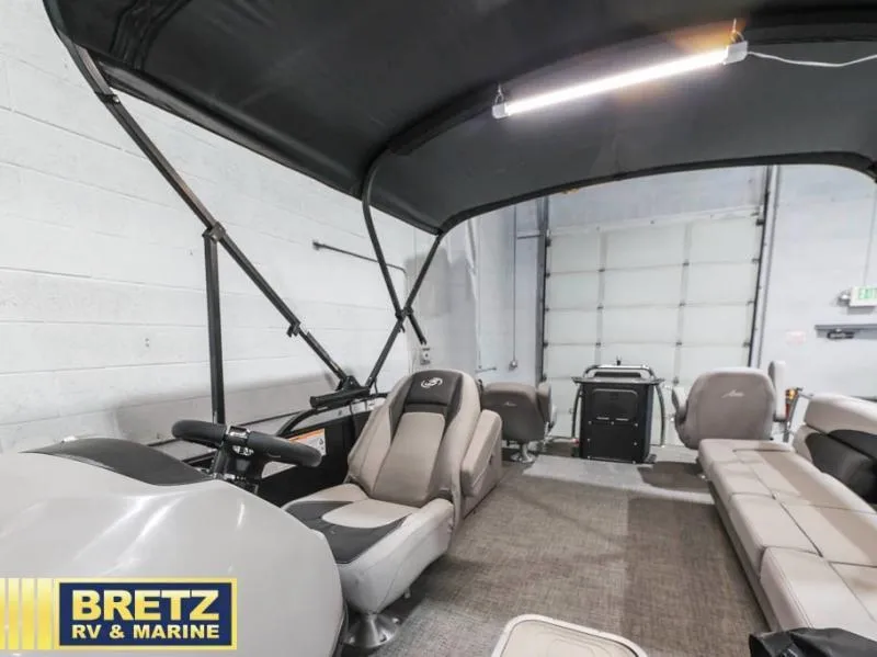 Slide: The Image of Interior of 2025 Aria Cast-N-Cruise A22CC boat with seating and canopy. - 16