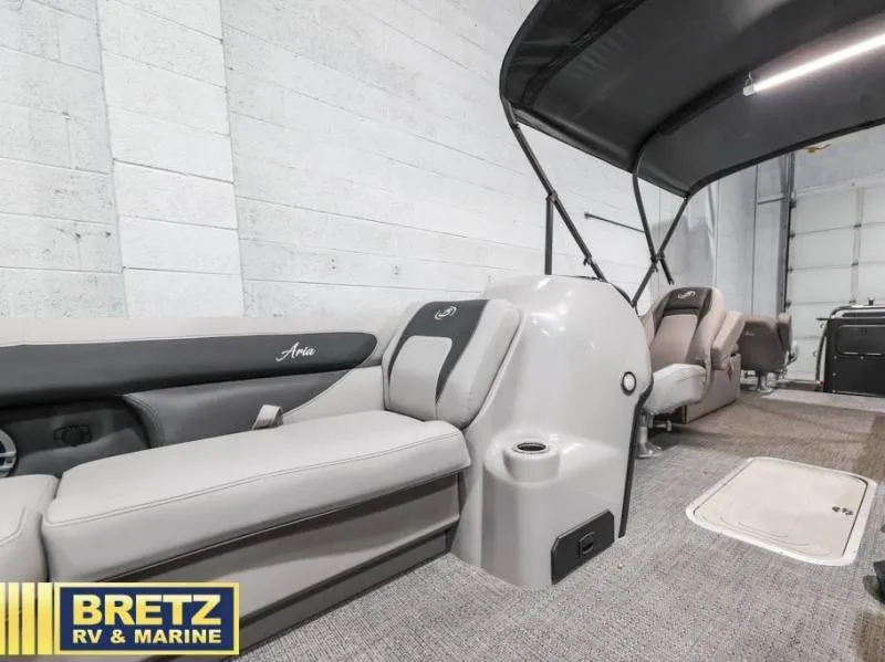 Slide: The Image of 2025 Aria Cast-N-Cruise A22CC boat interior with seating and canopy. - 17