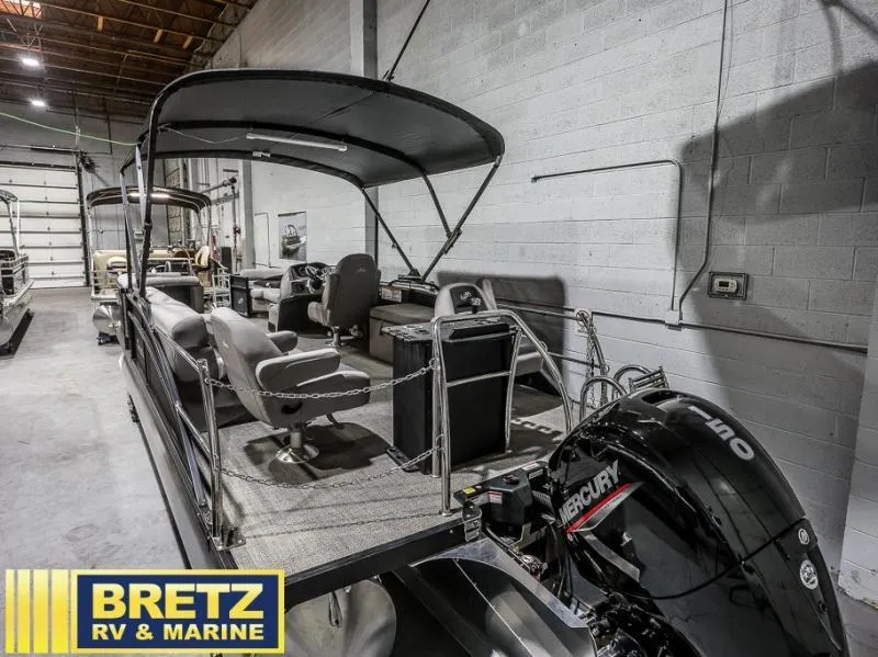 Slide: The Image of 2025 Aria Cast-N-Cruise A22CC boat in showroom with Mercury engine, Bretz RV & Marine. - 5