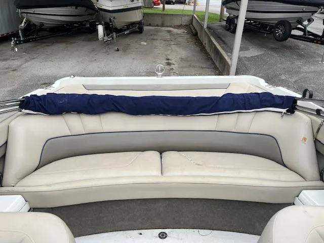 Slide: The Image of 1996 Cobalt 232 boat interior with beige seating and blue cover. - 6