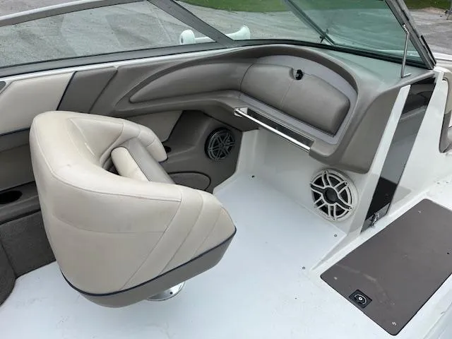 Slide: The Image of 1996 Cobalt 232 boat interior with beige seating and dashboard. - 7