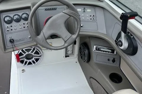 Slide: The Image of 1996 Cobalt 232 boat dashboard with steering wheel and control panel. - 9