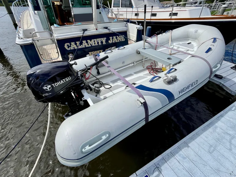 Slide: The Image of Highfield inflatable boat with Tohatsu motor docked near Sabre 45 Salon Express, 2018 model. - 10