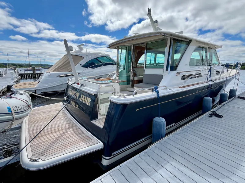 Slide: The Image of 2018 Sabre 45 Salon Express yacht docked at marina under blue sky. - 11