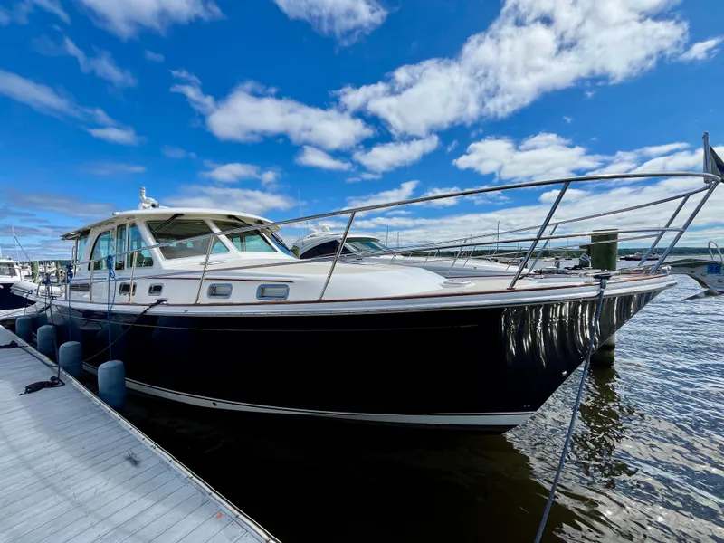 Slide: The Image of 2018 Sabre 45 Salon Express yacht docked under blue sky. - 12