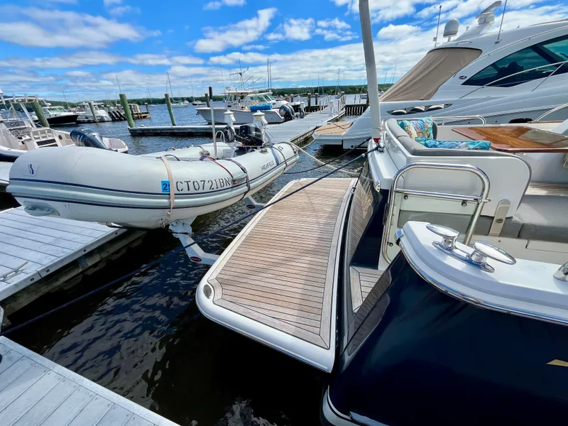 Slide: The Image of 2018 Sabre 45 Salon Express yacht docked with inflatable boat. - 13