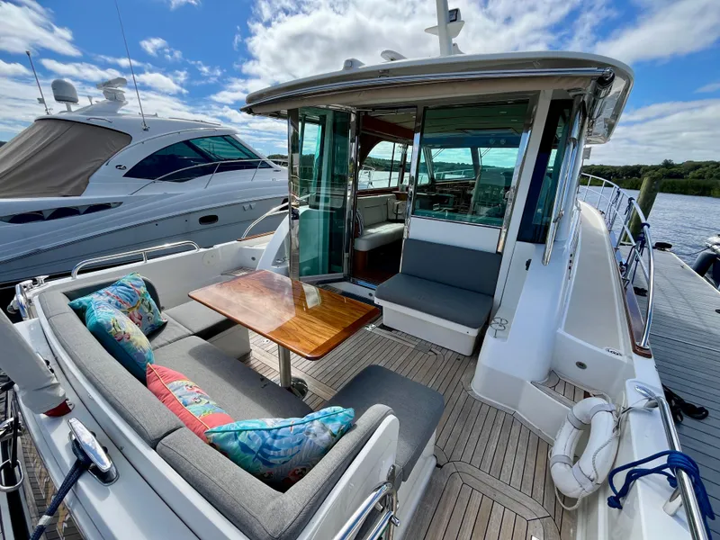Slide: The Image of 2018 Sabre 45 Salon Express yacht with outdoor seating and colorful cushions. - 15