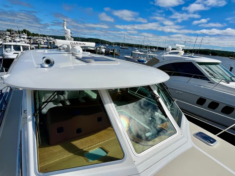 Slide: The Image of 2018 Sabre 45 Salon Express yacht docked at marina under blue sky. - 20