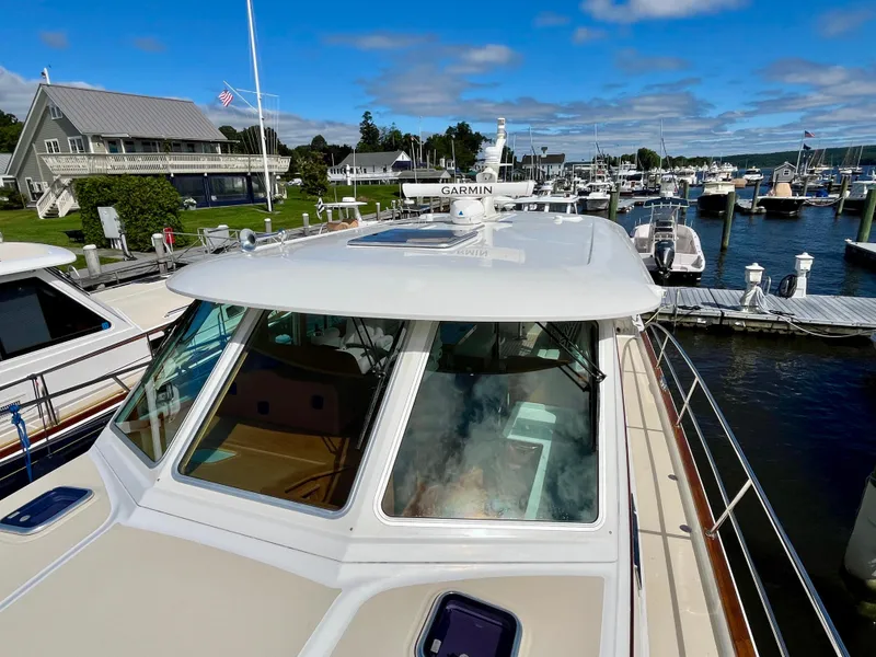 Slide: The Image of 2018 Sabre 45 Salon Express docked at a scenic marina. - 21