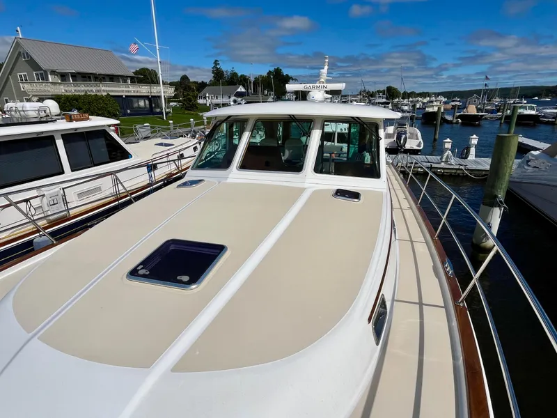 Slide: The Image of 2018 Sabre 45 Salon Express yacht docked at marina under blue sky. - 22