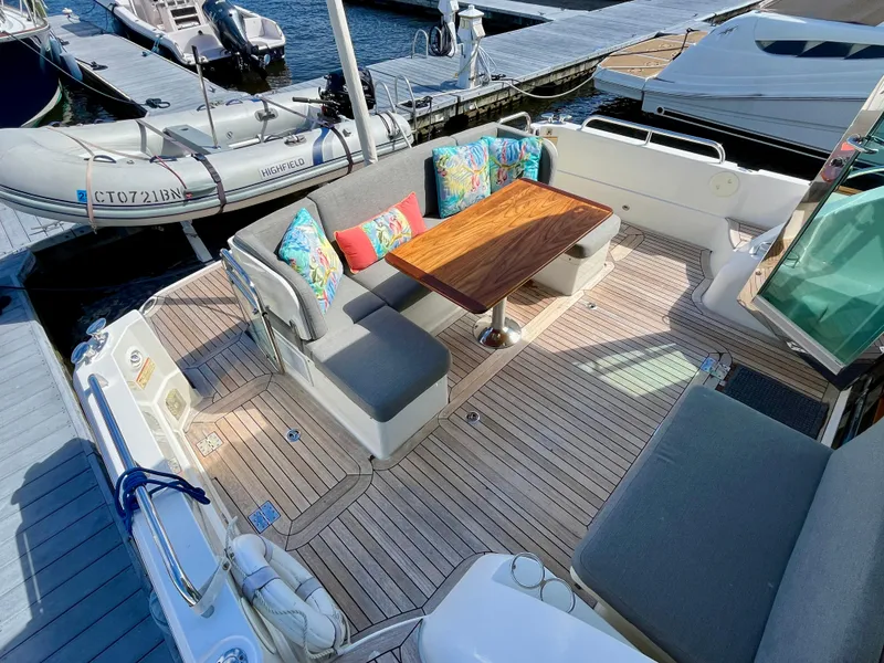 Slide: The Image of 2018 Sabre 45 Salon Express yacht with elegant outdoor seating and wooden table. - 23