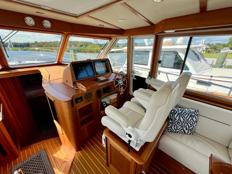 Slide: The Image of 2018 Sabre 45 Salon Express interior with helm, leather seating, and navigation screens. - 29